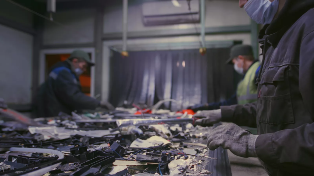 Electronic waste moving through a downstream sorting and processing facility